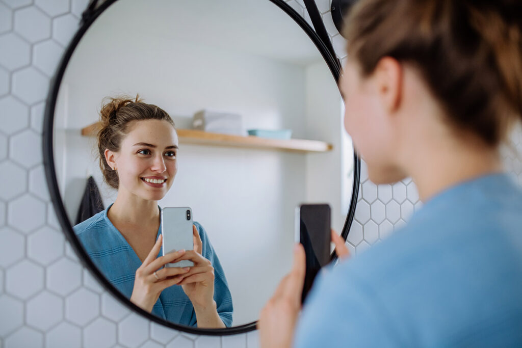 Young woman taking selfie in a bathroom