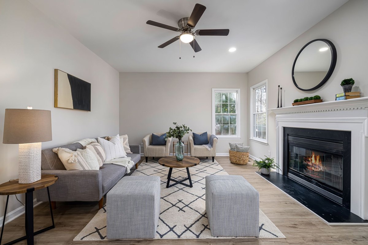 A wide-angle shot of a bright, decluttered living room with perfectly arranged furniture, ready for a photoshoot.