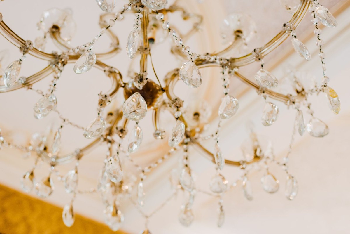 How a Crystal Chandelier Changes Light in a Small Room A close-up, eye-level shot of an elegant crystal chandelier, perfect for illustrating lighting in a small room.